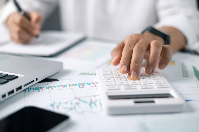 Person budgeting while feeling stressed about checking their bank account