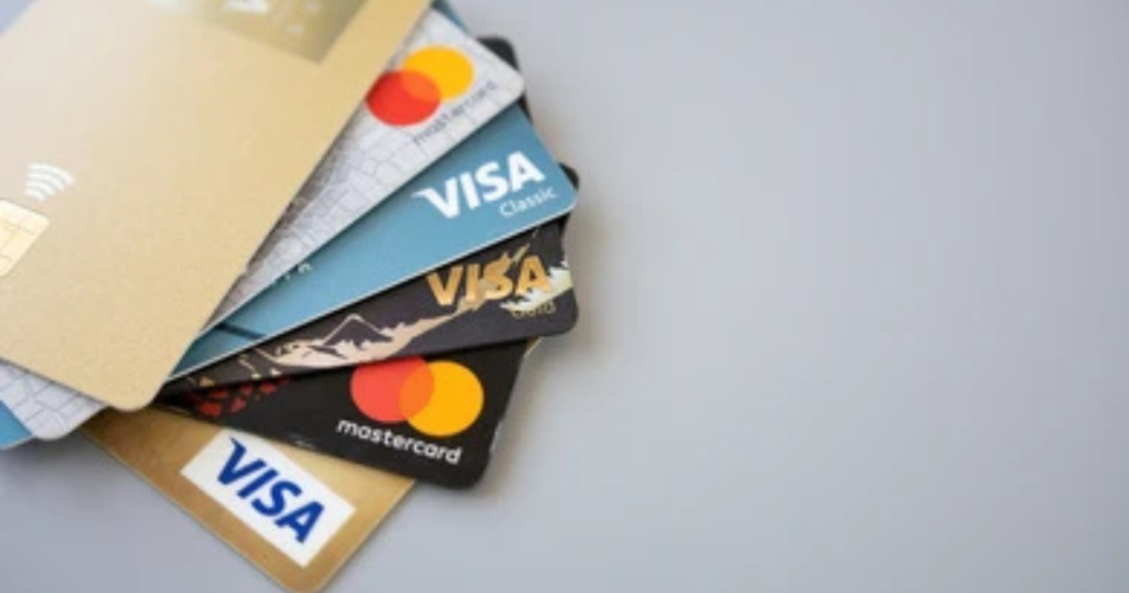 Credit card vs debit card side by side on a desk